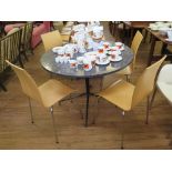 A 1960s blacked metal frame dining table, the circular marble effect formica top on a tapering