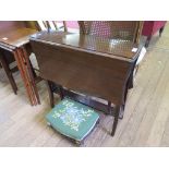 An Edwardian mahogany Sutherland table, with shaped top, rail supports and outswept legs, and an