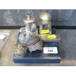 A collection of silver items to include a silver pepper mill, two small scent bottles, a cased set