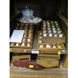 A large collection of commemorative ceramic thimbles, with display racks