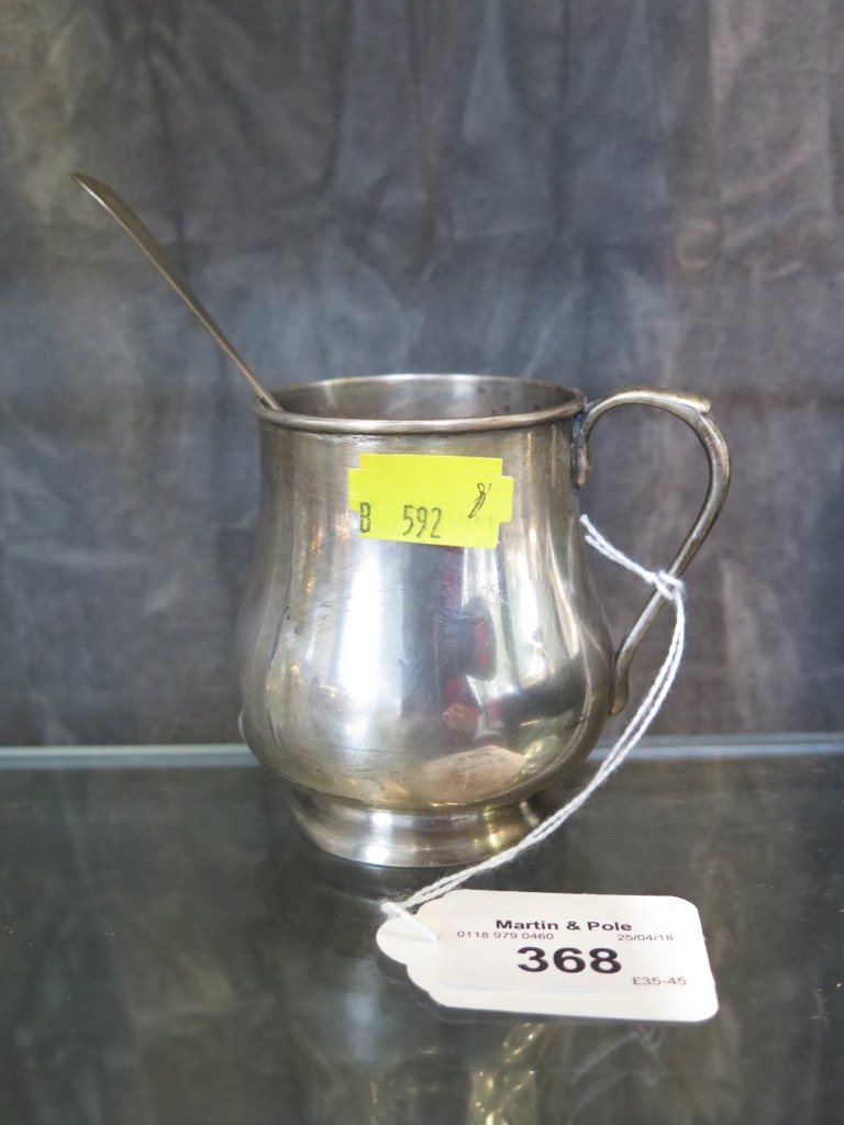 A silver baluster mug and a Georgian silver spoon