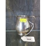 A silver baluster mug and a Georgian silver spoon