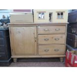 A Victorian pine dresser, the raised shaped back over a cupboard door beside three graduated drawers