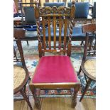 A Victorian carved oak chair with crimson velvet drop-in seat pad