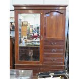 An Edwardian walnut wardrobe, with mirrored door beside a cupboard door and three short graduated