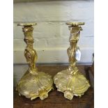 A pair of Rococo revival ormolu candlesticks, of scroll and cartouche form with detachable