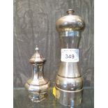 A silver pepper mill together with a silver pepper