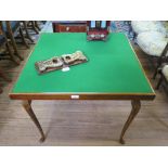 A stained beech bridge table, the baize top on folding cabriole legs with club feet