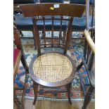 A pair of early 19th century mahogany bedroom chairs, the broad top rails over ball and spindle