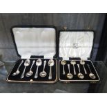 A cased set of silver tea spoons together with a cased set of silver coffee spoons