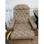 An Edwardian button upholstered walnut armchair, with turned supports and pot castors