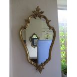 Two Italian style shaped gilt wood wall mirrors of scrolling form 71cm and 86cm high (2)