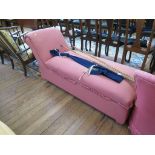 A pink upholstered day bed, with scroll arm and hinged seat, and a pink tub chair (2)