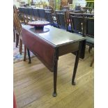 A George III mahogany Pembroke table, the rectangular top with lunette carved edge over turned