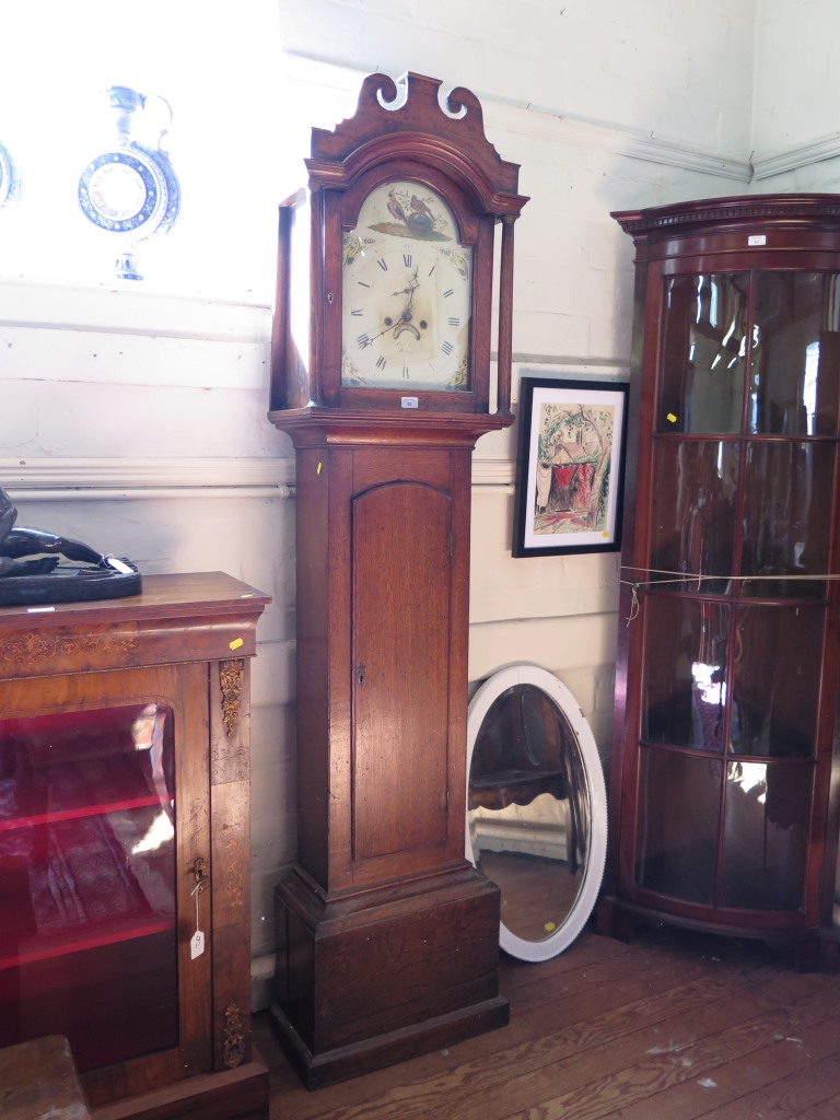A 19th century oak cased longcase clock, the swan neck pediment over a painted arch dial depicting