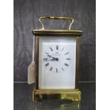 A Matthew Norman brass carriage timepiece with single train movement and enamel dial 17cm high