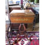 A Regency rosewood and brass inlaid teapoy, with ring handles, the hinged lid enclosing four caddies