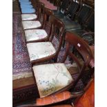 A set of five early Victorian dining chairs, the broad top rails above drop in seats on lotus carved