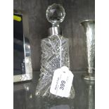 A moulded glass scent bottle with a silver collar