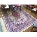A Kashmir design carpet, the central red medallion on an ivory field, filled with flowers and