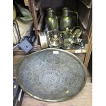 An Eastern brass circular tray depicting animals in foliate decoration, 59cm diameter, a pair of