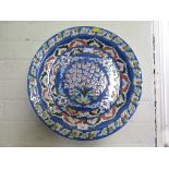 A large Turkish Iznic style Kutahya pottery wall hanging charger 42cm diameter signed by decorator