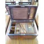 A 19th century mahogany and brass bound dressing box, the hinged lid enclosing a fitted interior,