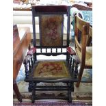 An Ebonised American rocking chair, with turned supports