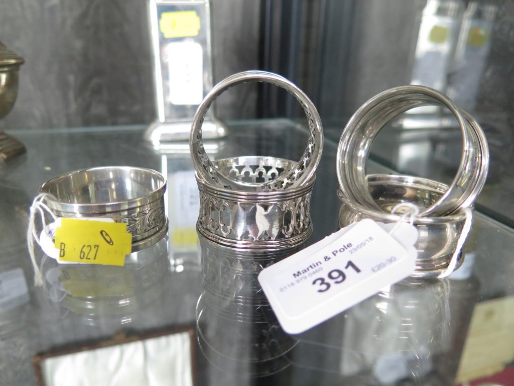 Three silver napkin rings and two plated napkin rings