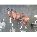 A Royal Doulton figure of a horse, 18.5cm high and a similar Beswick figure of a foal