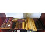 Writing accessories including eight wood rulers, seven wood pen trays, a pencil block, pen nibs