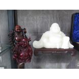 A green glass Chinese figure of Buddha 15cm on carved stand and two Chinese carved hardwood figures