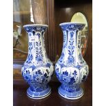 A pair of Delft blue and white vases, stamped WZK, of baluster form with floral decoration 26cm