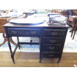 An Edwardian lady's ebonised writing table, the leather inset top over a drawer and kneehole