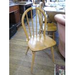 An Ercol elm top drop leaf table, on tapering square legs 113cm wide, and four Ercol hooped back