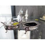 A three piece silver cruet complete with blue liners and spoons