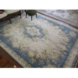 An European style wool carpet, the blue floral central medallion and spandrels on an ivory ground