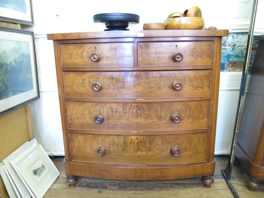 A Victorian mahogany bowfront chest of drawers, with two short and three long graduated drawers on