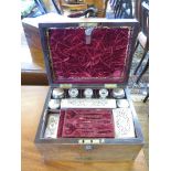 An early Victorian rosewood dressing box, the rectangular case with Bramah lock enclosing bottles,