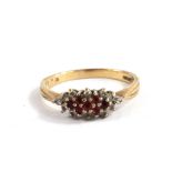 A 9 carat gold ring set with rubies and possibly diamonds