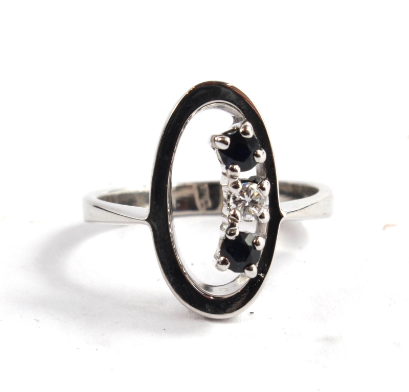 An 18 carat white gold designer diamond and sapphire ring