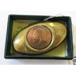 A brass twist tobacco box inset with a George V penny, 7.5cm wide
