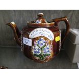 A Measham Barge Ware teapot with floral decoration and panel inscribed 'A Present to Phillis from