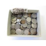 A green box of coins and two bank notes