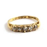 An 18 carat gold ring set with five diamonds