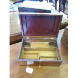 A mahogany box with brass escutcheon 28cm x 19cm x 11cm