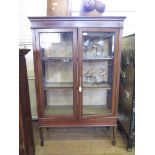 An Edwardian mahogany and satinwood crossbanded display cabinet, with twin glazed doors on square