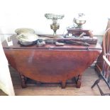 An 18th century style oak gateleg table, the oval top over a frieze drawer on turned and block