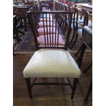 A late George III mahogany dining chair, the reeded rail back above an overstuffed seat on square