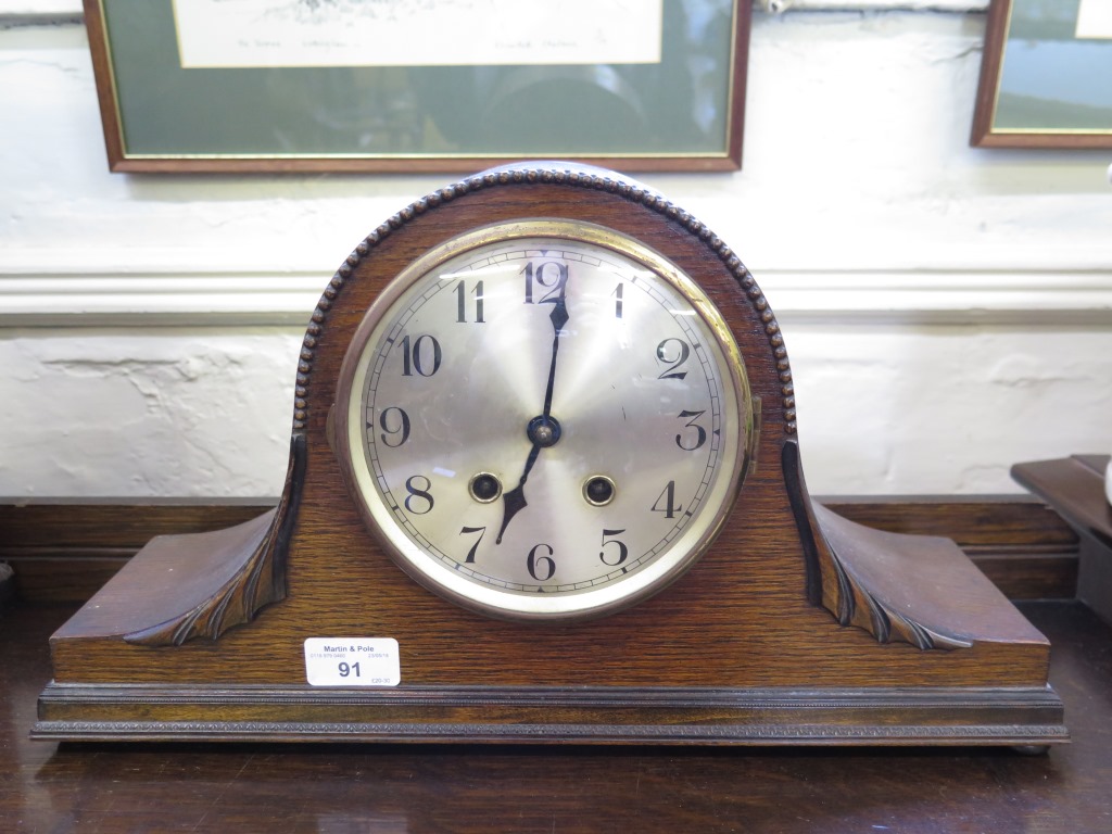 An oak 'Admiral Hat' mantel clock with silvered dial, a Victorian clock movement and dial in a later